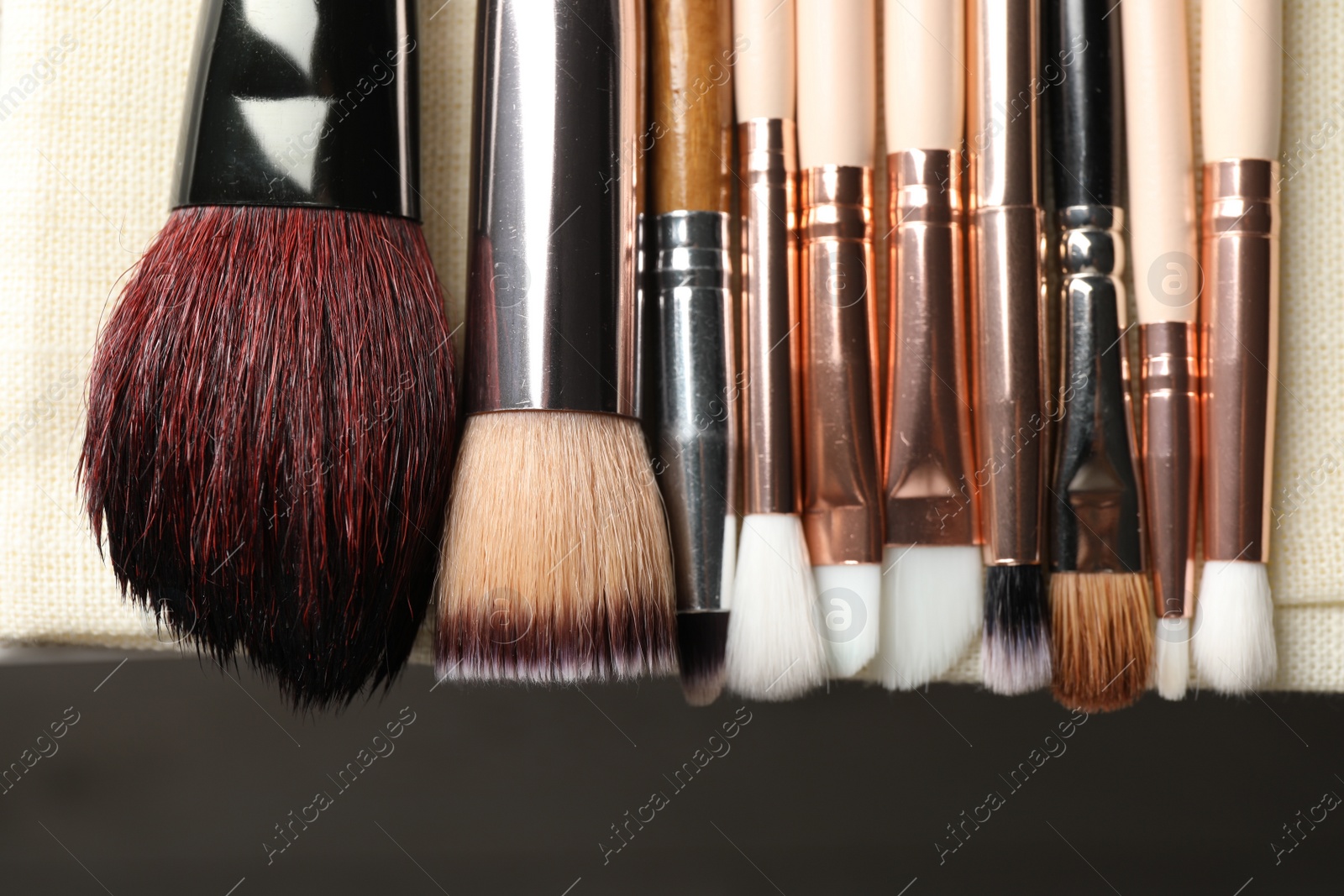 Photo of Set of different makeup brushes drying after cleaning on table, flat lay