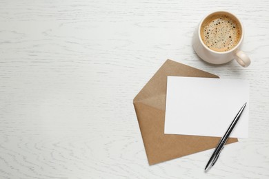 Photo of Envelope with blank paper card, cupcoffee and pen on white wooden table, flat lay. Space for text