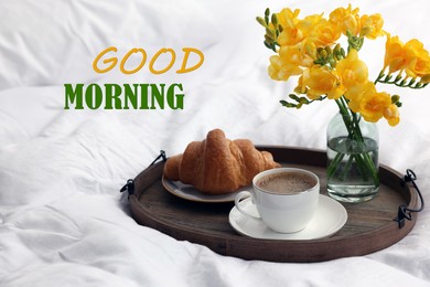 Good Morning! Cup of coffee, croissant and flowers on bed