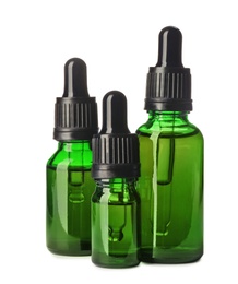 Photo of Cosmetic bottles of essential oils on white background