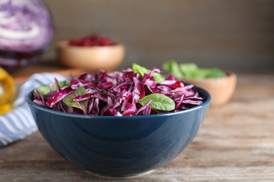 Fresh red cabbage salad served on wooden table, closeup