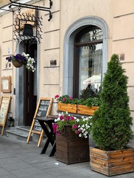 Photo of WARSAW, POLAND - JULY 17, 2022: Beautiful view of street with modern outdoor cafe