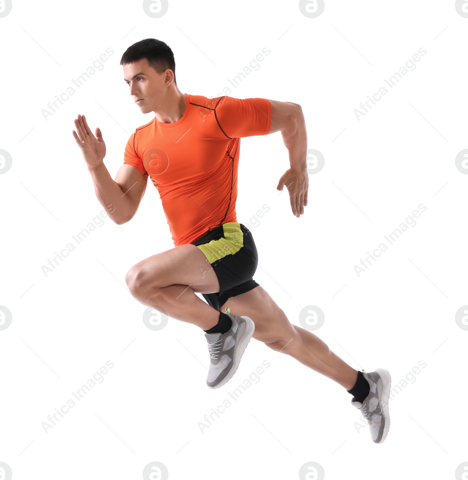 Photo of Athletic young man running on white background, side view