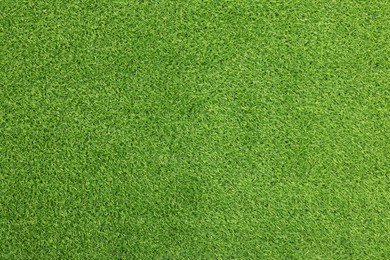 Photo of Green artificial grass as background, top view