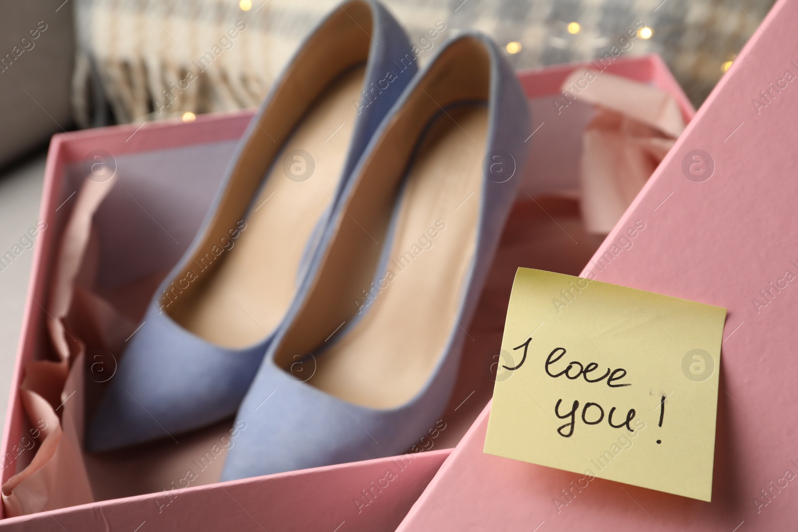 Photo of Note with phrase I Love You attached to cover of shoes box