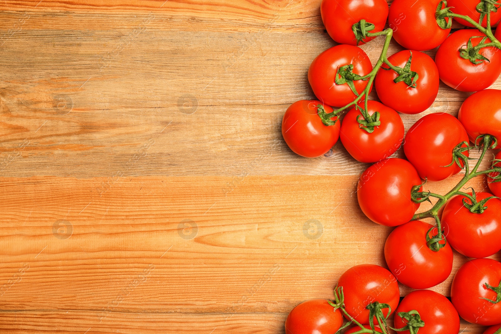 Photo of Flat lay composition with ripe tomatoes on wooden background