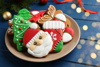 Different tasty Christmas cookies and decor on blue wooden table, closeup. Space for text