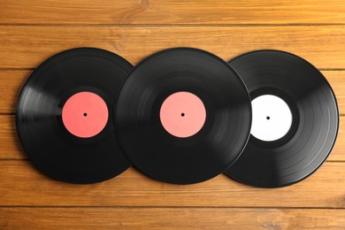 Vintage vinyl records on wooden table, flat lay