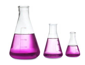 Photo of Conical flasks with purple liquid on white background
