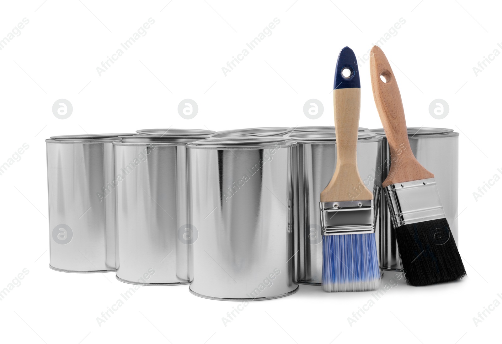 Photo of Cans of paints and brushes on white background