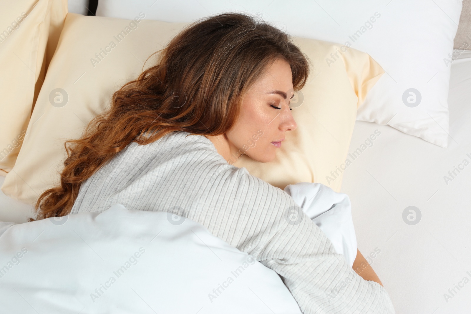 Photo of Beautiful woman sleeping in bed, top view