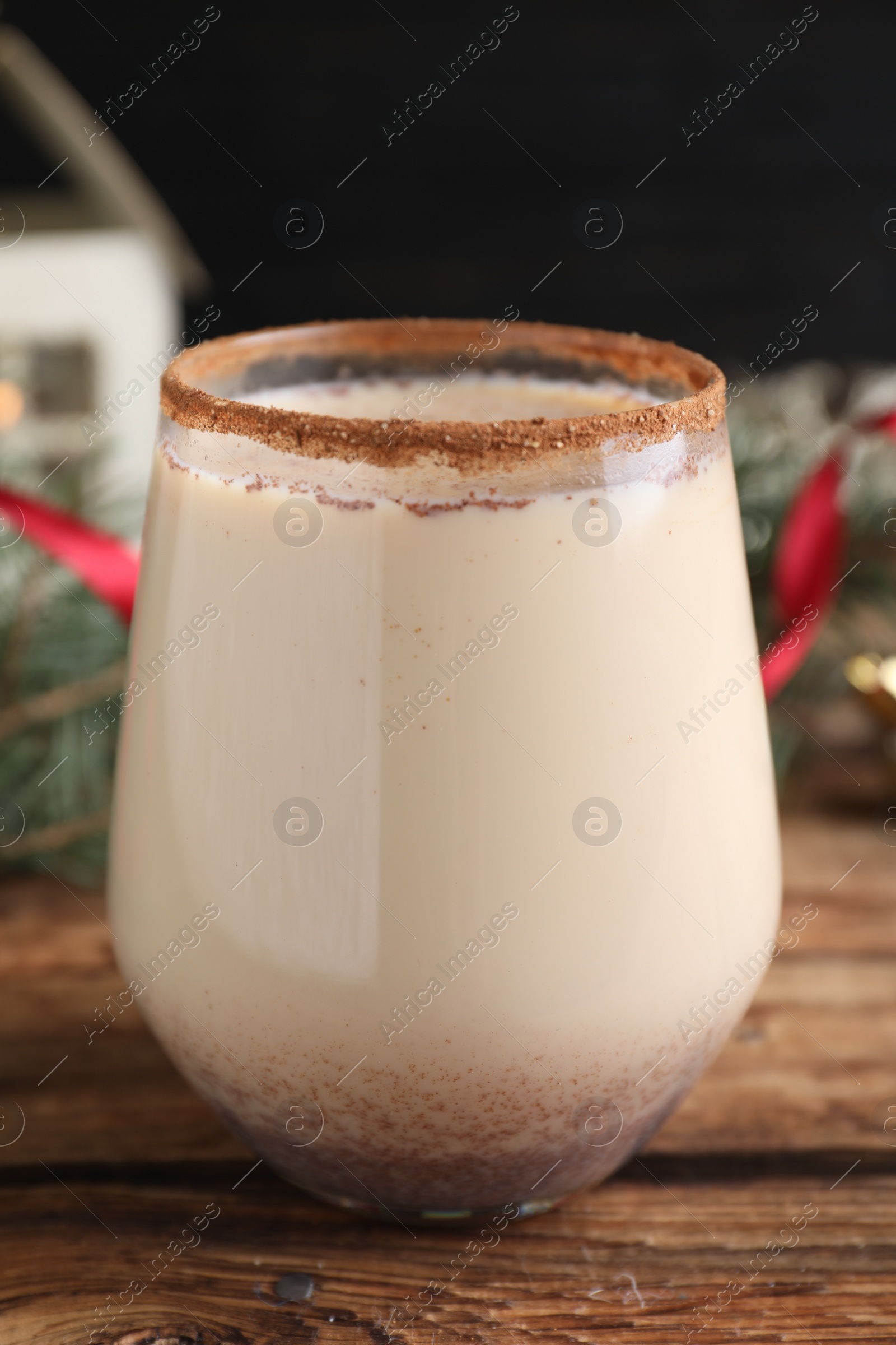 Photo of Delicious Christmas liqueur on wooden table, closeup