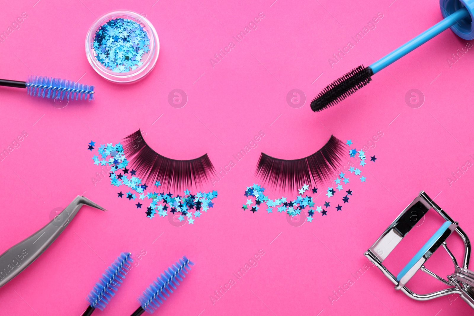 Photo of Flat lay composition with false eyelashes on pink background