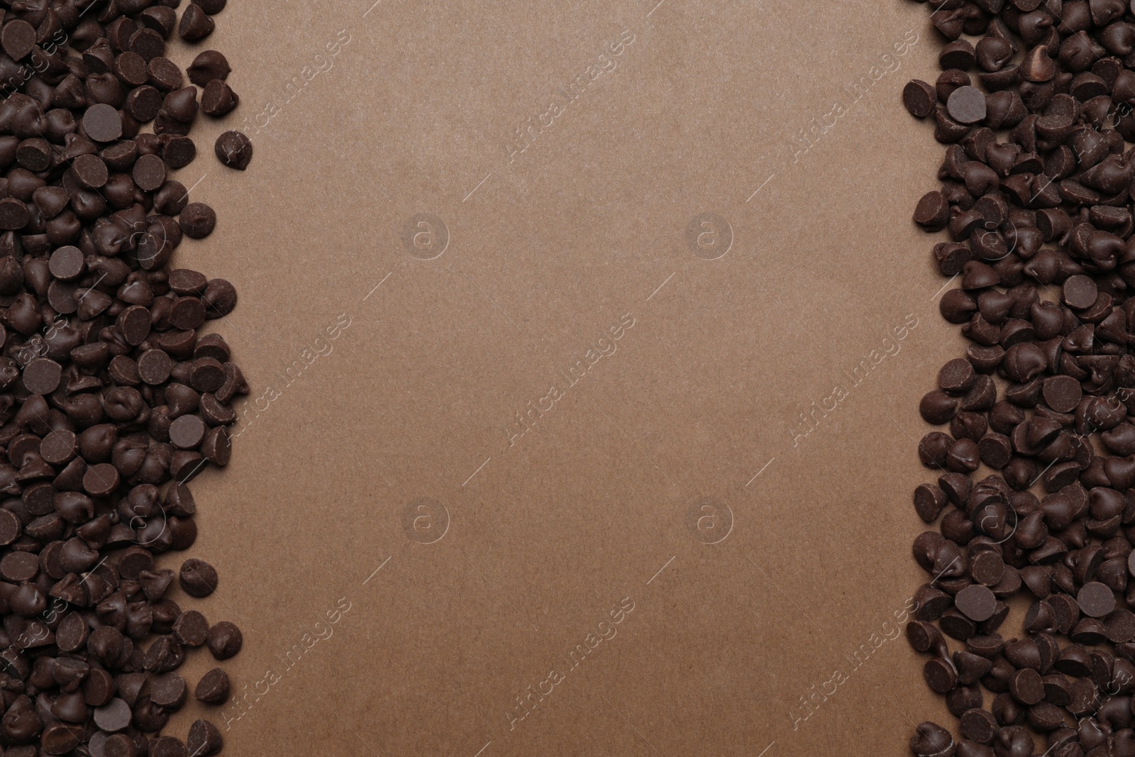 Photo of Delicious chocolate chips on brown background, top view. Space for text