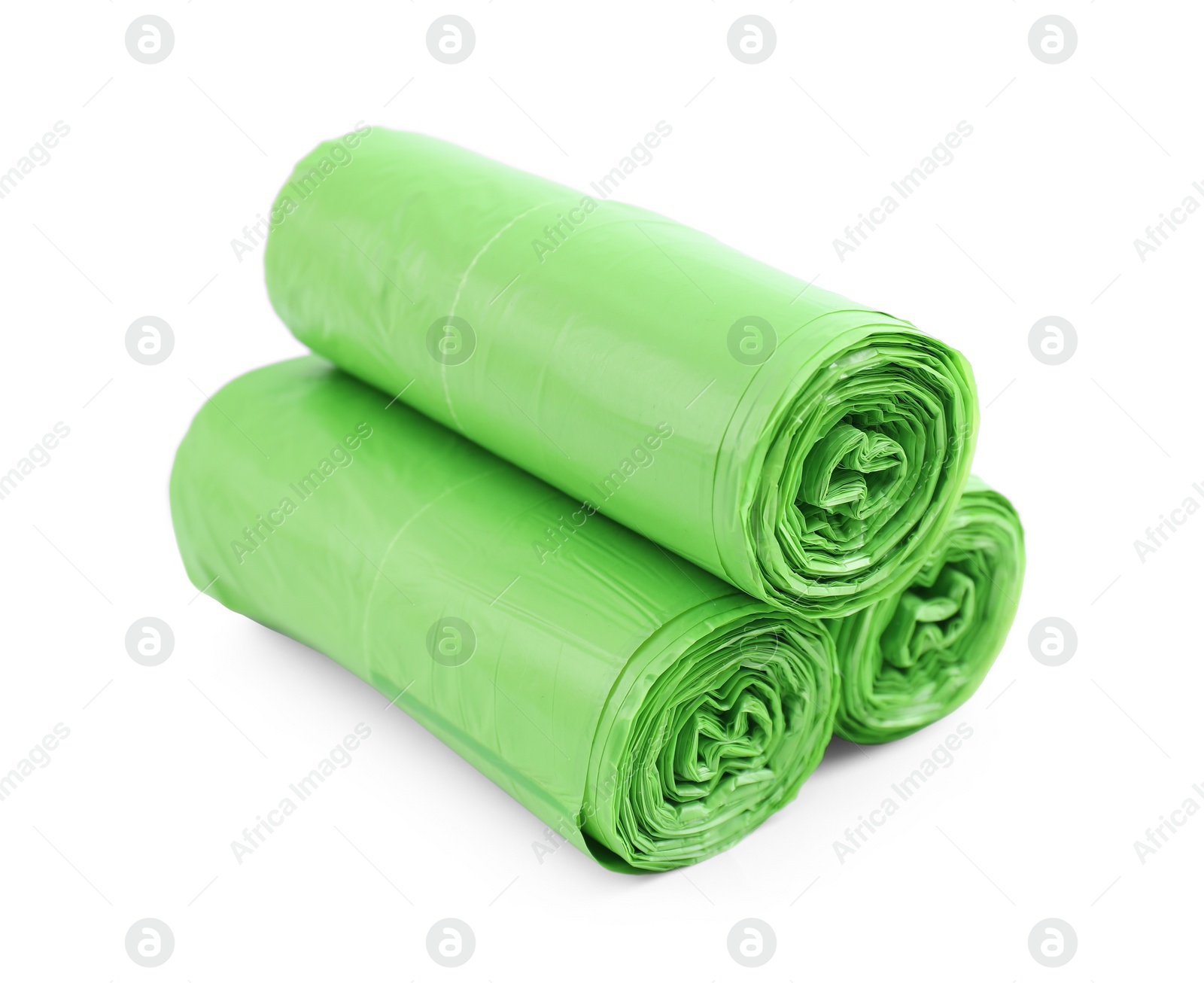 Photo of Rolls of light green garbage bags isolated on white