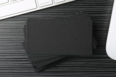 Blank black business cards on wooden table, top view. Mockup for design