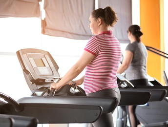 Photo of Overweight woman training in gym