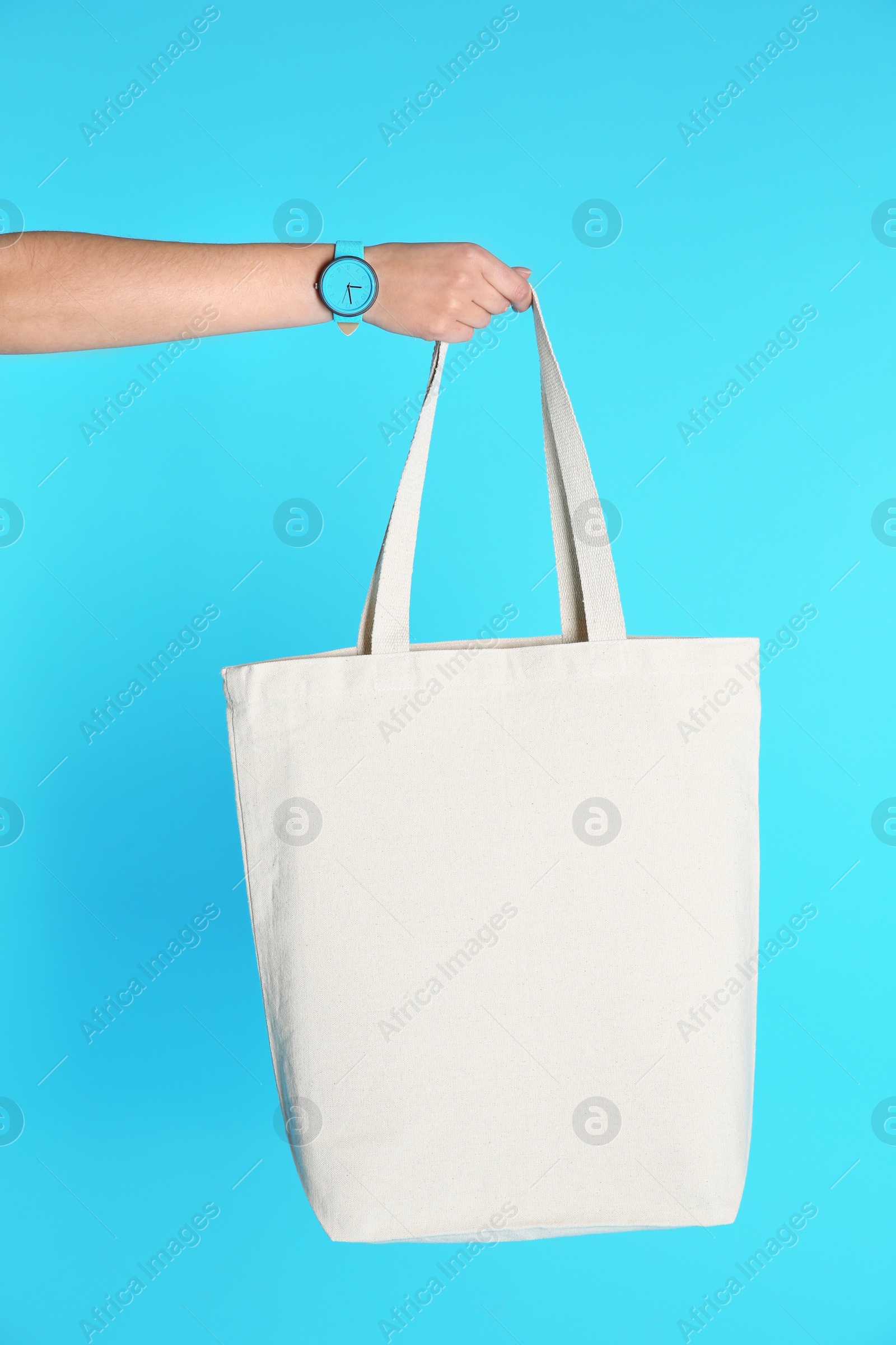 Photo of Woman holding eco bag on color background. Mock up for design