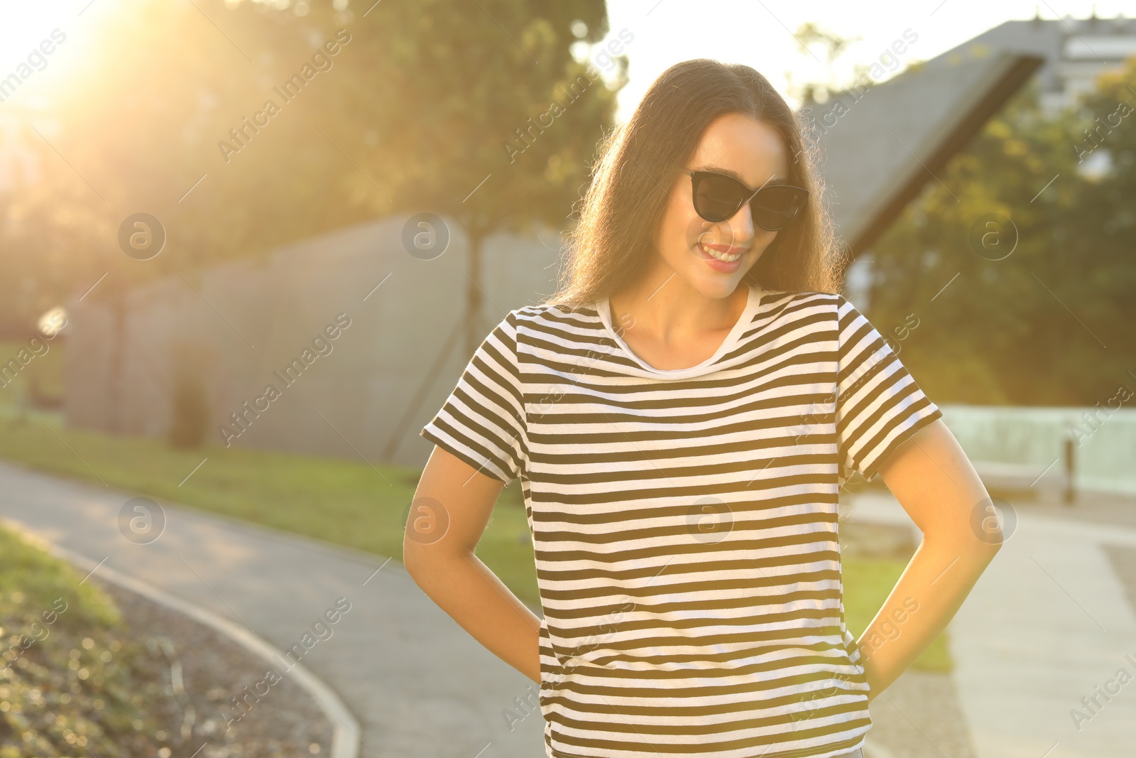 Photo of Beautiful smiling woman in sunglasses outdoors, space for text