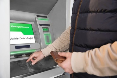 Image of Man entering cash machine pin code, closeup