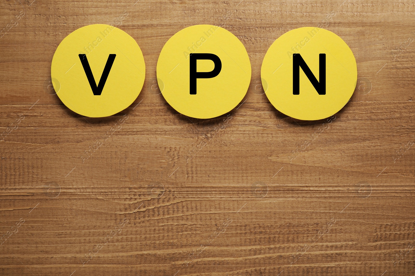 Photo of Paper notes with acronym VPN on wooden table, flat lay. Space for text