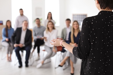 Photo of Female business trainer giving lecture in office