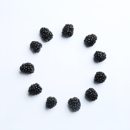 Photo of Frame made with fresh blackberries on white background, top view. Space for text