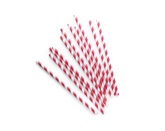 Photo of Striped paper cocktail straws on white background, top view