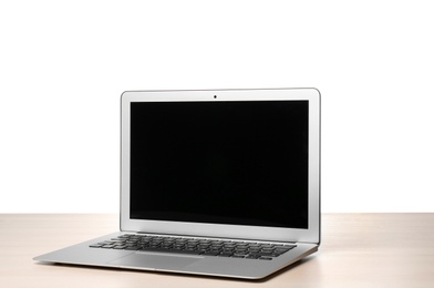 Photo of Modern laptop with blank screen on table against white background