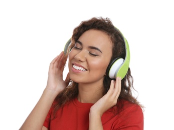 Photo of African-American girl listening to music with headphones on white background