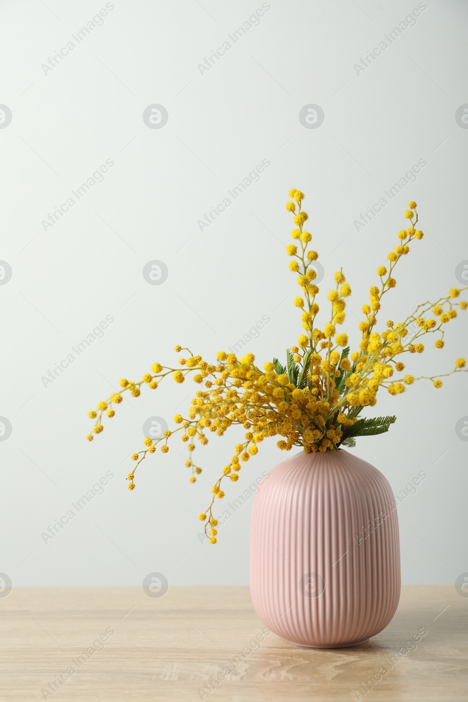 Photo of Bouquet of beautiful mimosa flowers on wooden table