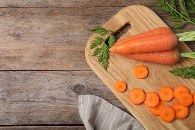 Photo of Flat lay composition cut carrot on wooden background. Space for text