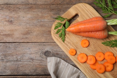 Flat lay composition cut carrot on wooden background. Space for text