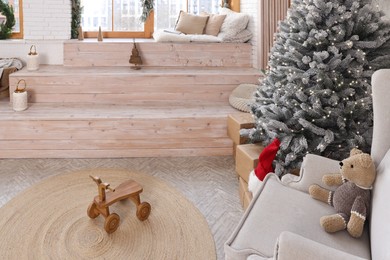 Stylish room interior with Christmas tree and festive decor
