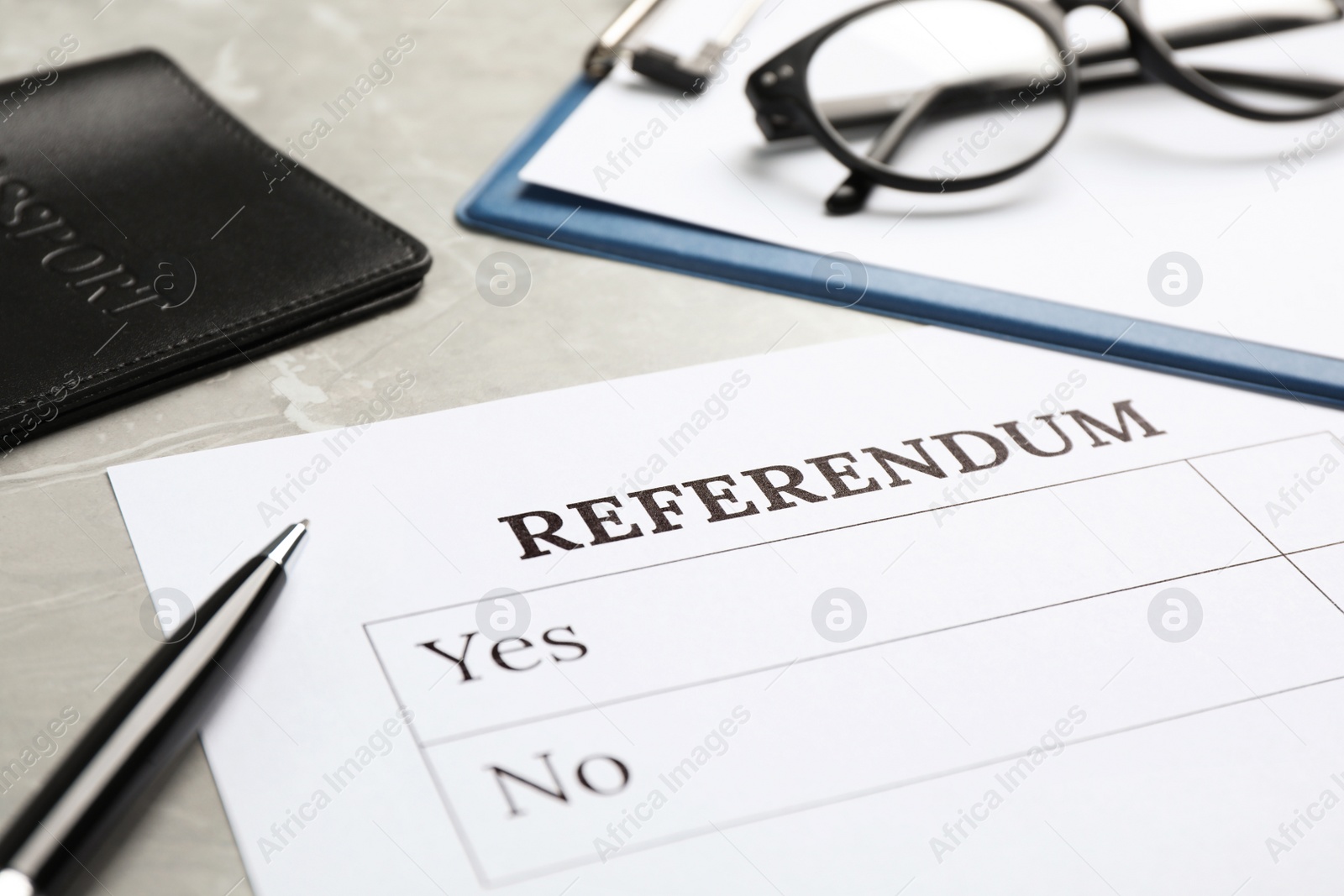 Photo of Composition with referendum ballot on light grey marble table, closeup