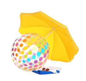 Photo of Open yellow beach umbrella, inflatable ball, towels and sunglasses on white background