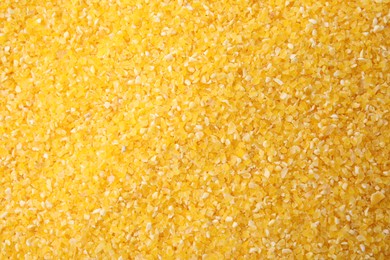 Photo of Raw corn grits as background, top view