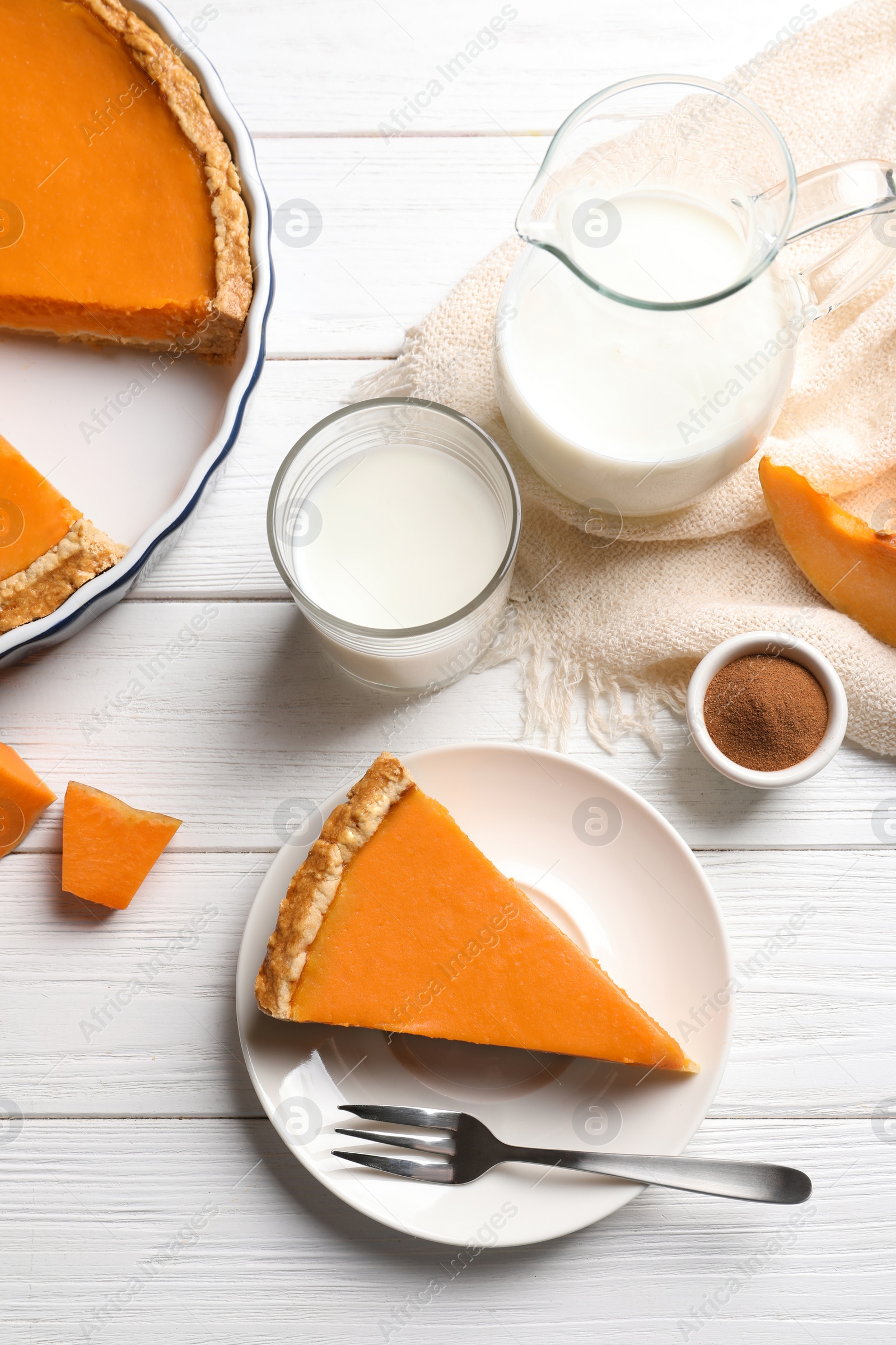 Photo of Flat lay composition with piece of fresh delicious homemade pumpkin pie on wooden background