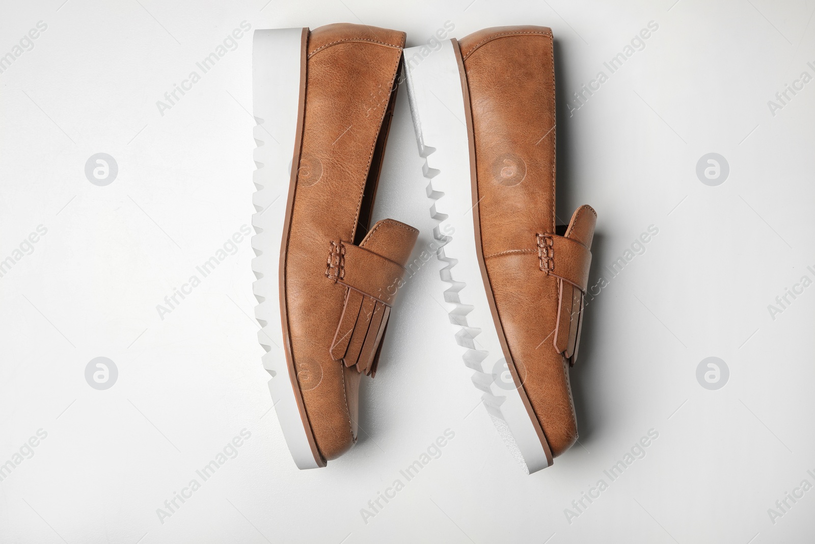 Photo of Pair of female shoes on white background