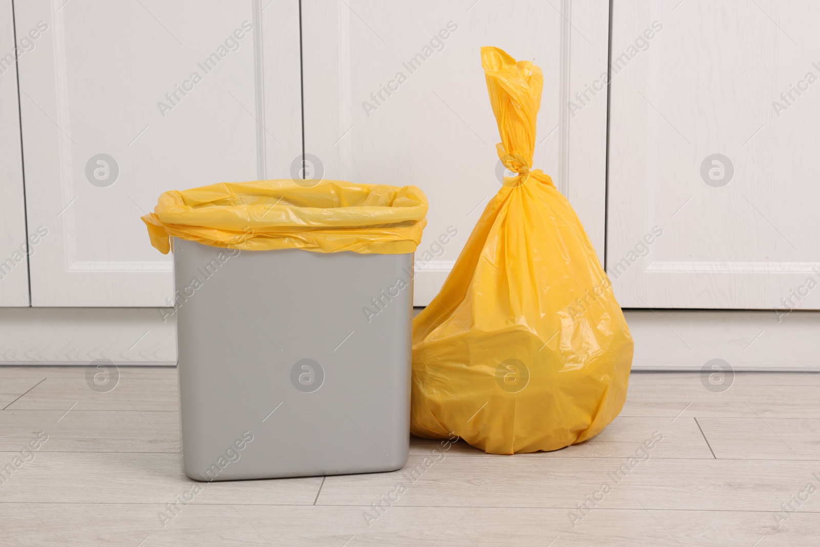 Photo of Plastic garbage bag and trash can indoors