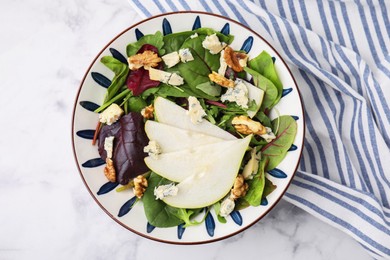 Photo of Delicious pear salad in bowl on white marble table, top view