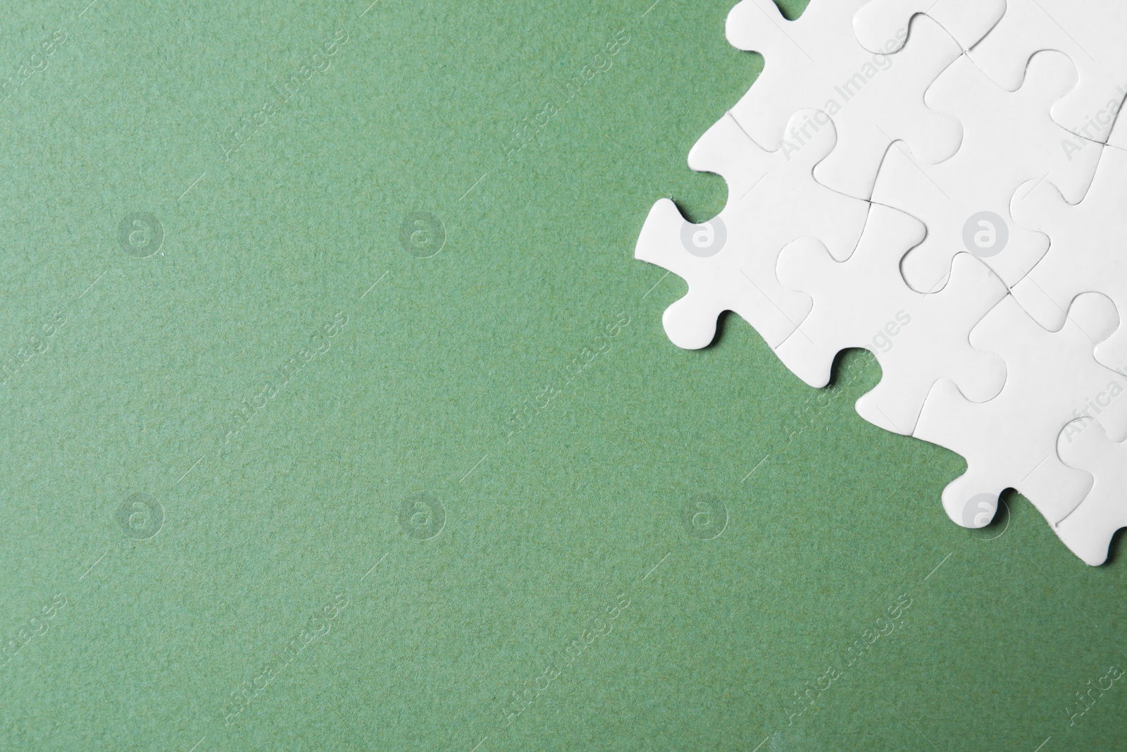 Photo of Blank white puzzle pieces on grey background, flat lay. Space for text