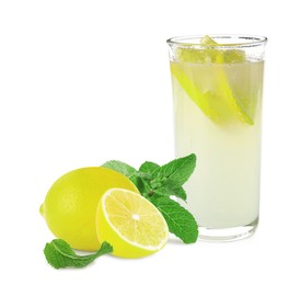 Glass with tasty lemonade, fresh ripe fruits and mint on white background