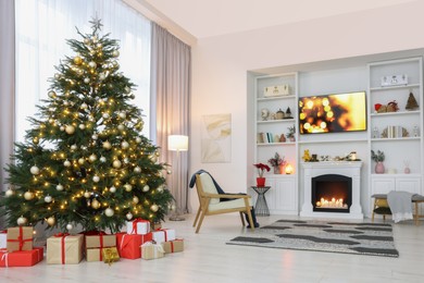 Beautiful tree with festive lights and Christmas decor in living room. Interior design