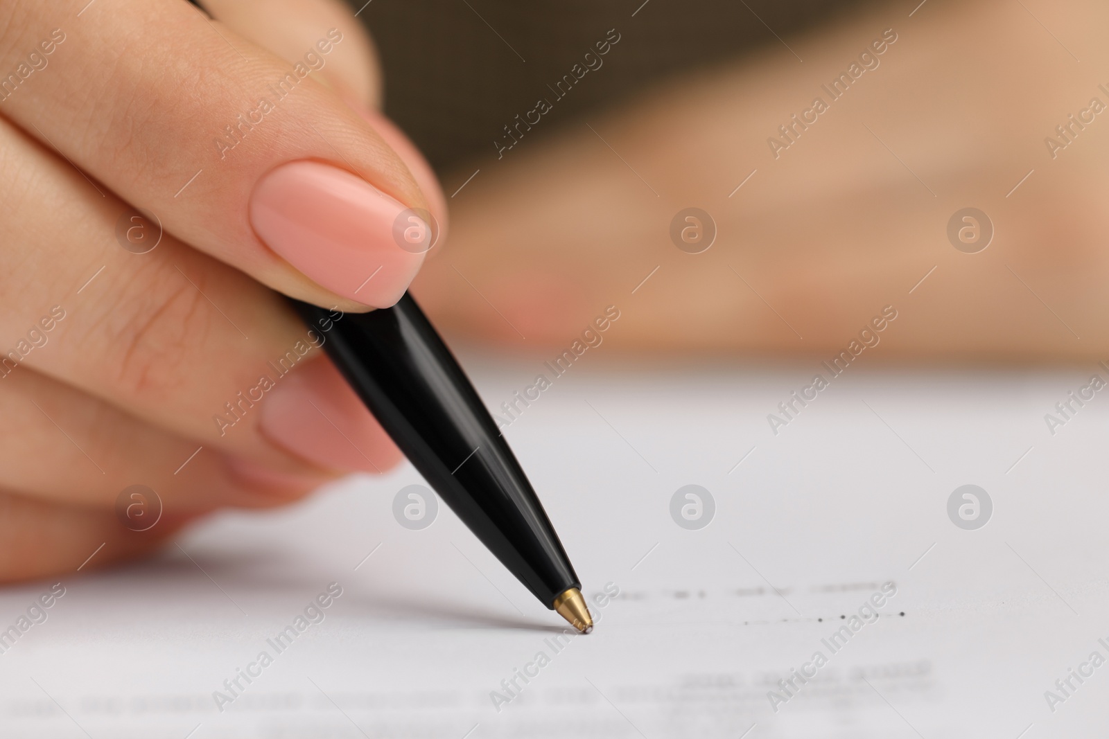 Photo of Woman signing document, closeup view. Space for text