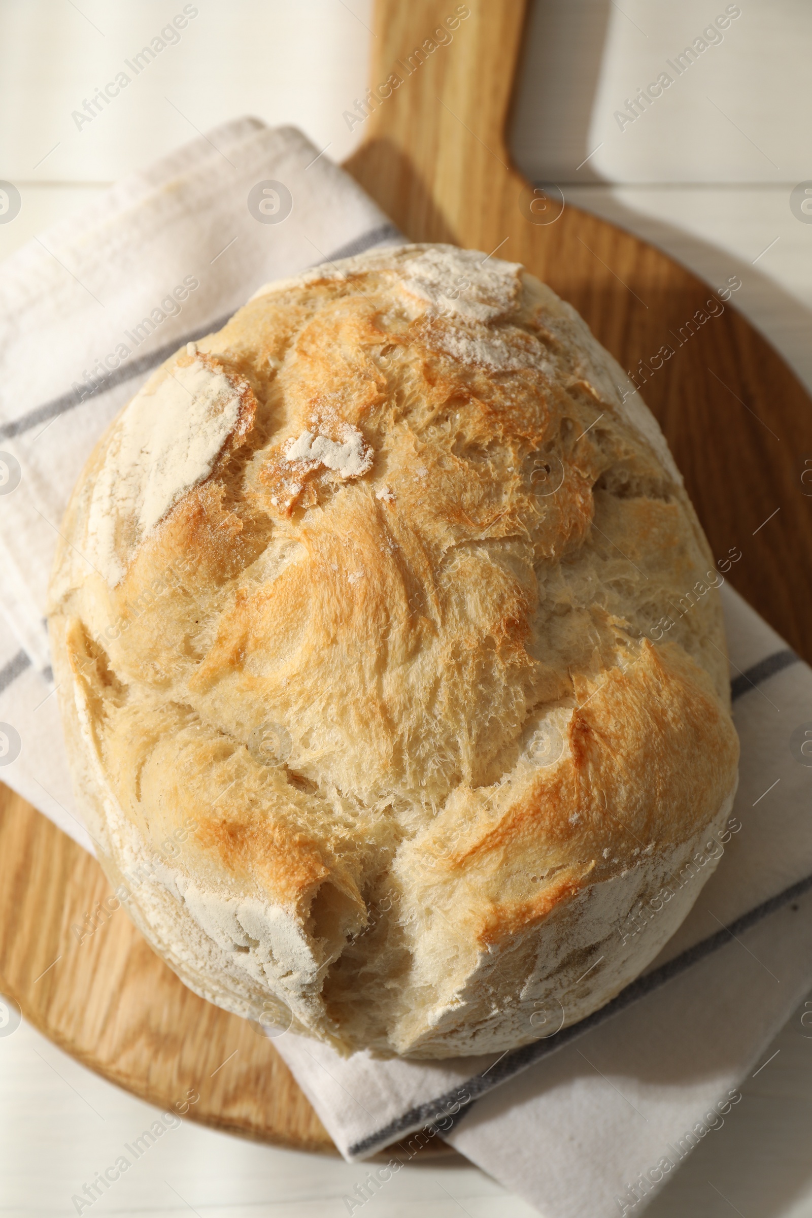 Photo of Freshly baked sourdough bread on white table