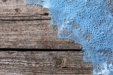 Photo of Beautiful lace on wooden table, top view. Space for text