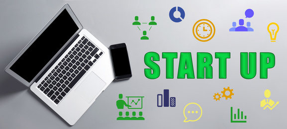 Image of Startup idea. Modern laptop, mobile phone and different icons on gray background, banner design