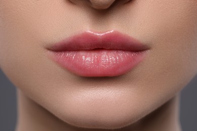 Photo of Young woman with beautiful plump lips, closeup
