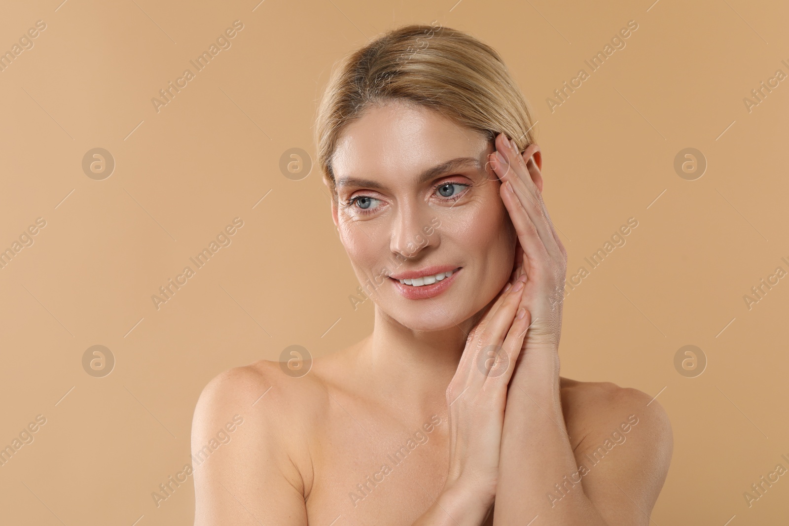 Photo of Beautiful woman with healthy skin on beige background